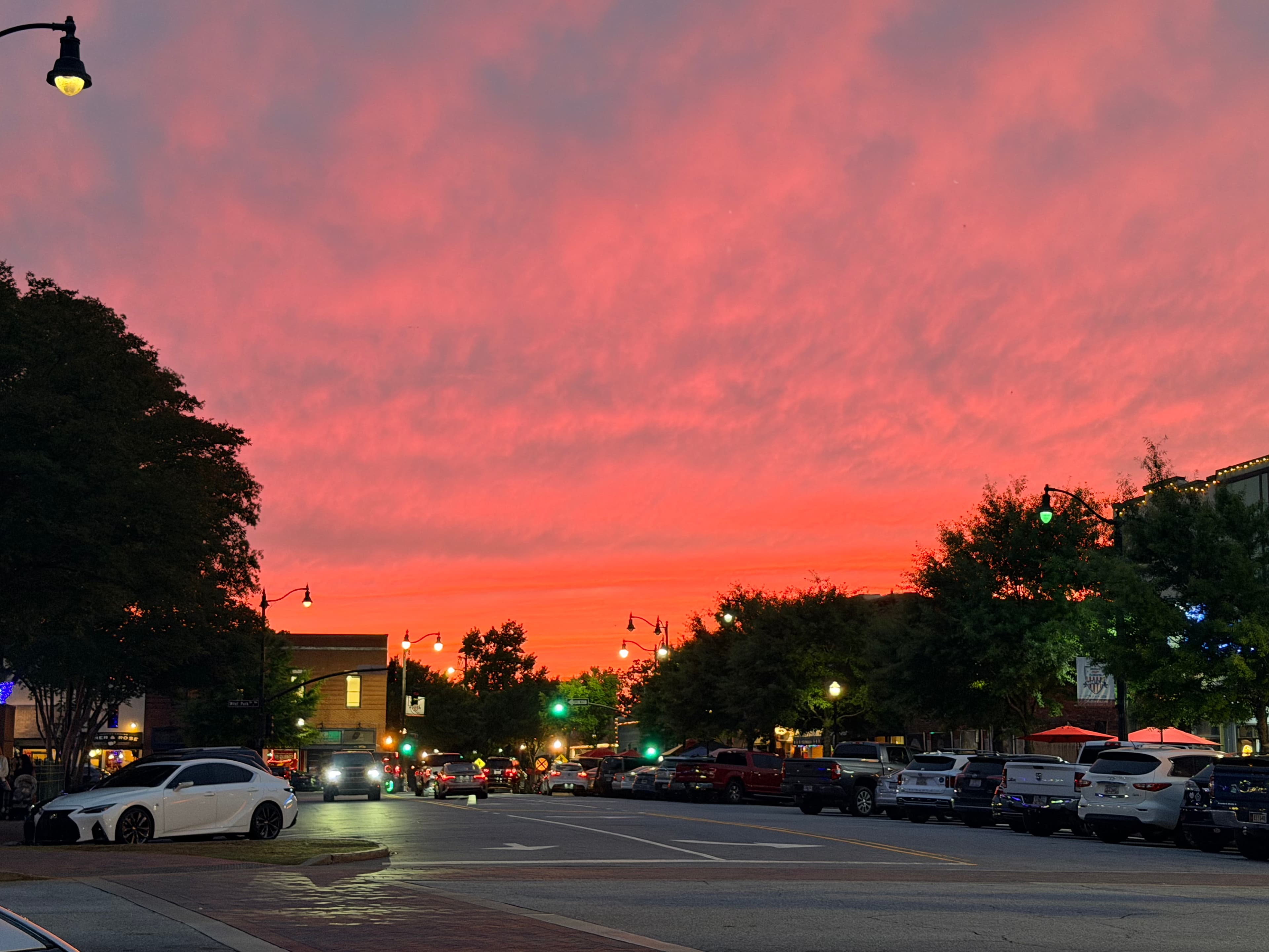 Downtown street under a pink and orange sunset